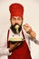 Chef eats italian or asian noodles. Man with beard
