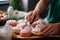 Chef expertly garnishes delectable donuts with creamy buttercream in a cozy kitchen