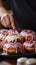 Chef expertly garnishes delectable donuts with creamy buttercream in a cozy kitchen