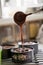 Chef filling baking tins with chocolate cake mix