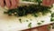 Chef finely chopping parsley or coriander leaves; closeup