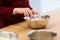 Chef with flour in bowl making batter or dough