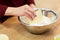 Chef with flour in bowl making batter or dough