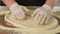 Chef forming dough for pizza and kneading it with hands