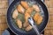 Chef frying chicken wings in pan