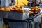 Chef is frying Chinese deep fried dough in hot oil on steel pan