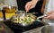 Chef is frying eggplant with herbs