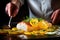 a chef garnishing baked cod with lemon slices