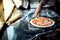 Chef is garnishing mozzarella cheese on a top or surface of pizza. He is cooking and preparing for baking pizza. He cook at