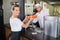 Chef giving burgers to waitress in commercial kitchen