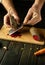 The chef grates beets to prepare a salad for dinner. Idea of cooking fresh vegetables on the kitchen table