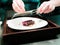 Chef Grating Spice on Deer Meat with Peanut