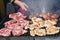 Chef grilling meat during cookout picnic or food event. Meat mix variety, Labour Day, 1 Mai