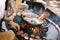 The chef grills meatballs for mini burgers on the grill.