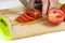 Chef Hand and Knife Slicing Tomato