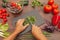 Chef hands chop fresh parsley on rustic wooden table