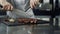 Chef hands cutting steak at kitchen restaurant. Closeup chef slicing meat