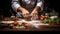 chef hands dusting a wooden table with flour