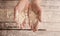 Chef hands with flour over a wooden table