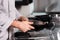 Chef hands with knife at kitchen restaurant. Closeup hands of male check knife.