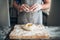 Chef hands mix dough with egg, bread preparation