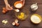 Chef hands pour sugar into a bowl for making dough on wooden table