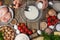 Chef hands pours some soda into glass bowl with milk for cooking dough on wooden table with variety of ingredients background.