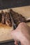 Chef hands slicing beef steak with knife