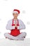 Chef in hat of Santa doing yoga with snow