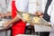 Chef Holding Small Pizzas On Baking Sheet In