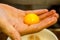 The chef holds an egg yolk in the palm of his hand,one way to separate it from the protein