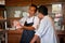 Chef Instructing Trainee In Restaurant Kitchen