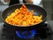 chef itir fry propellers pasta with sauce pan in professional restaurant kitchen