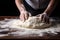 The chef is kneading the dough. Hands close up