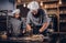 Chef kneading dough in the kitchen. Chef teaching his assistant to bake the bread in the bakery.