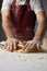 Chef kneading dough with rolling pin