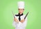 Chef with knives against green background