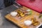 Chef lays out meat and potatoes on a wooden plate for guests in a pub.