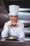 Chef leaning on the counter with a dish