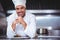 Chef leaning on the counter with a dish