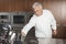 Chef Leaning For Knife In Commercial Kitchen