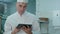 Chef looking for recipes on digital tablet in the professional kitchen
