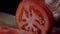 Chef making burger. Closeup mans hands cutting tomato for hamburger.