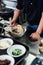 Chef making Hakata style Chashu Ramen by holding ramen noodle in Shio soup with chopsticks