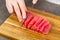 Chef making sashimi in kitchen, fresh raw tuna meat. seafood diet