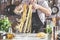 Chef making spaghetti noodles with pasta machine on kitchen table with some ingredients around