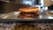 Chef making tasty burger. Cheeseburger with beef patty, cheese, tomato, onion.