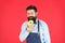 Chef man in cafe. Food calorie. Bearded man in apron. Donut food. Diet and healthy food. baker hold donut. Funny hipster