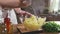 Chef mashes potatoes in a glass bowl, cooking food in the kitchen, boiled vegetables, vegetarian meal, healthy food