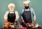 Chef men cooking. Father and son culinary hobby. Family restaurant. Selected ingredients. Mature bearded men